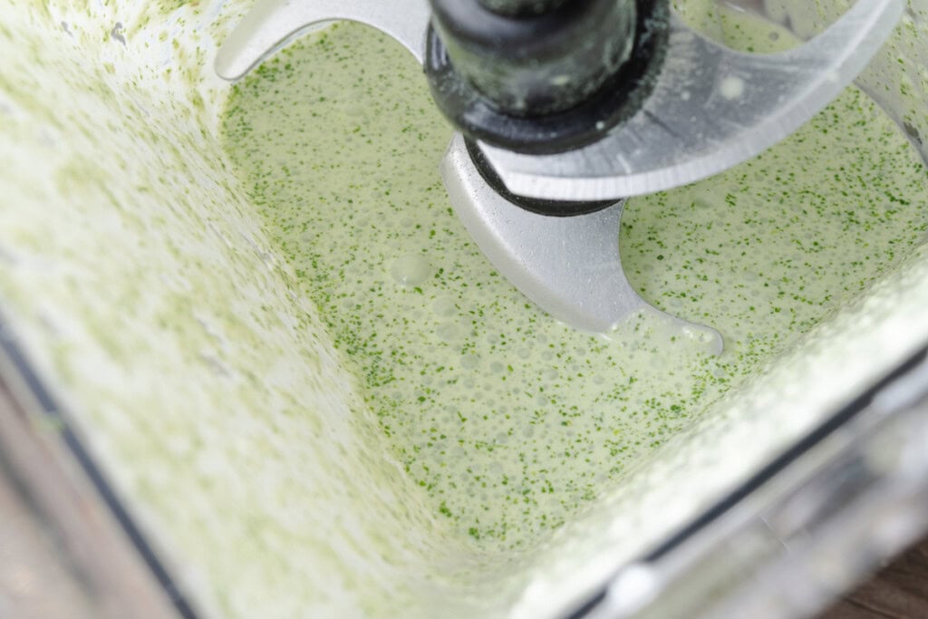 Cilantro lime cream sauce in a blender.