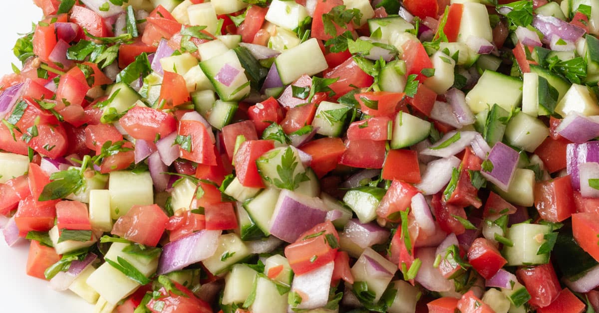 Mediterranean cucumber and tomato salad with red onions and parsley.