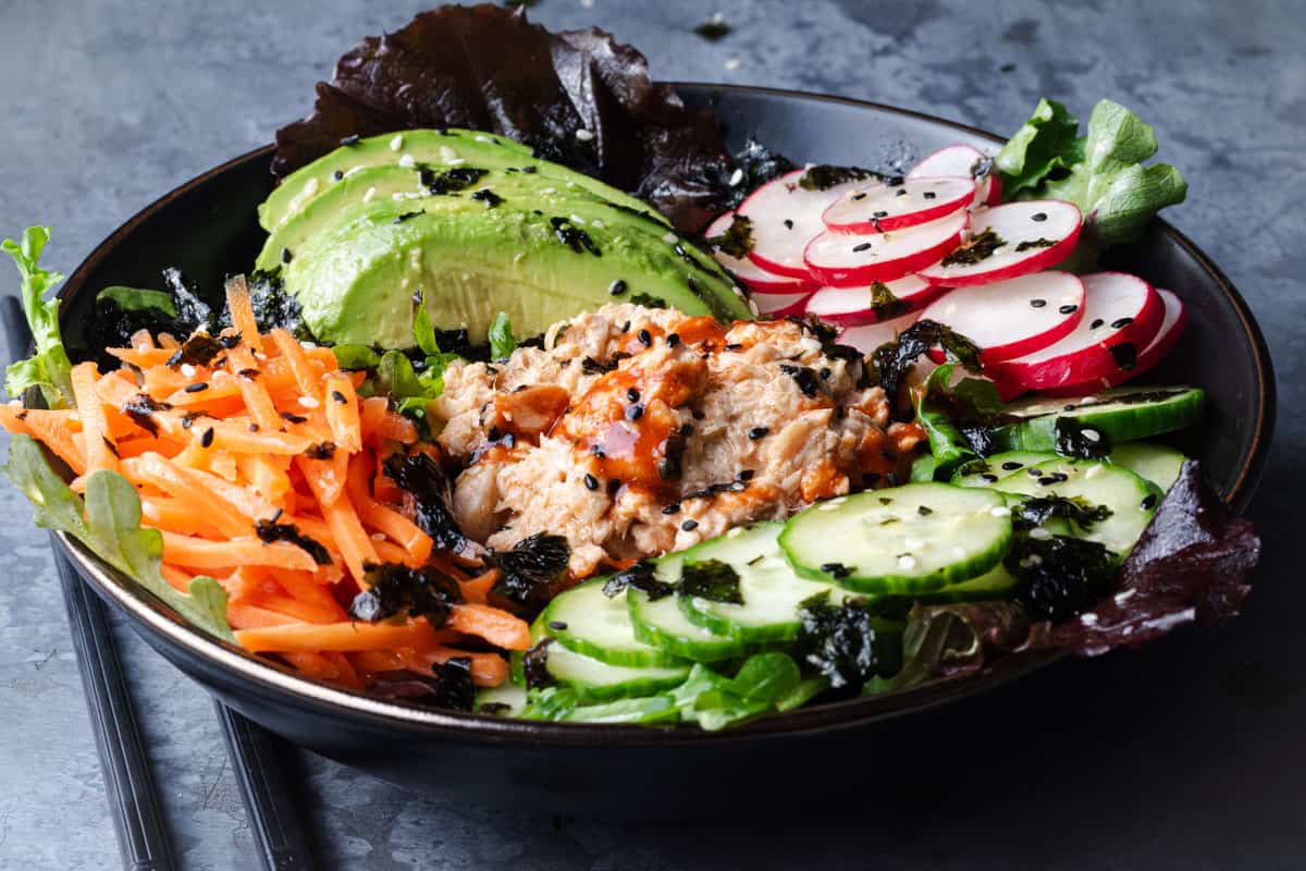 A bowl of spicy salmon salad with Japanese-inspired sushi seasonings.