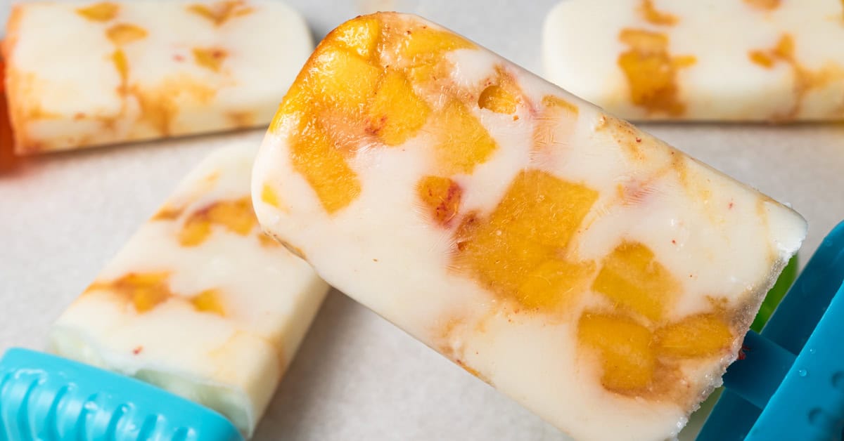 A popsicle with yogurt and chunks of peaches.