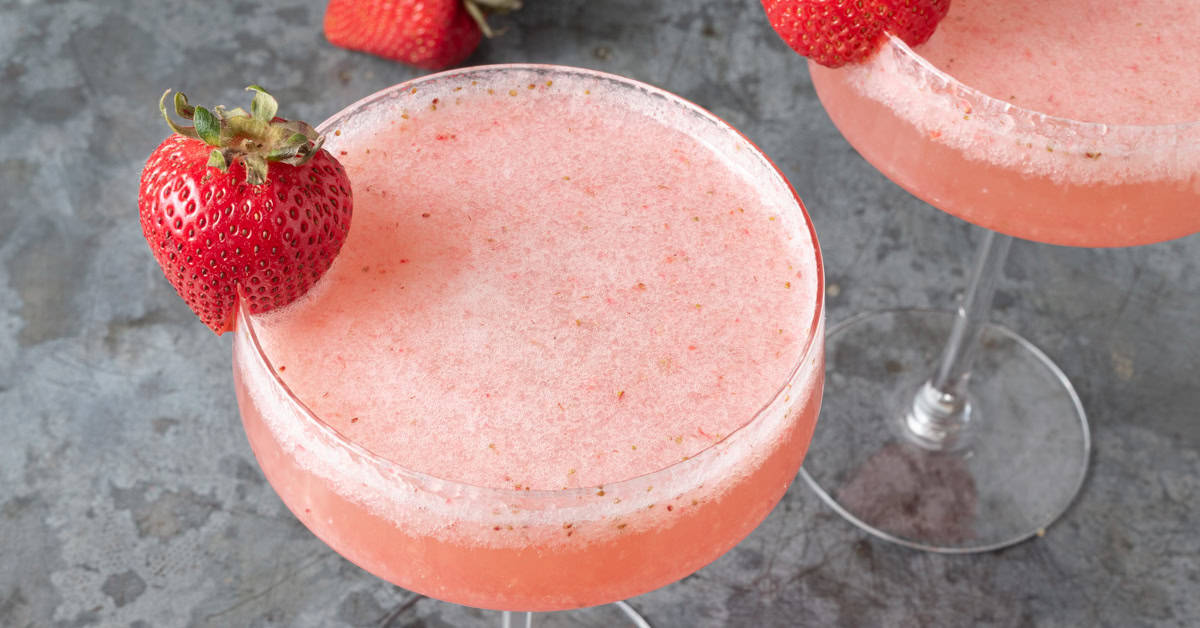 A strawberry Rossini cocktail in a coupe glass.