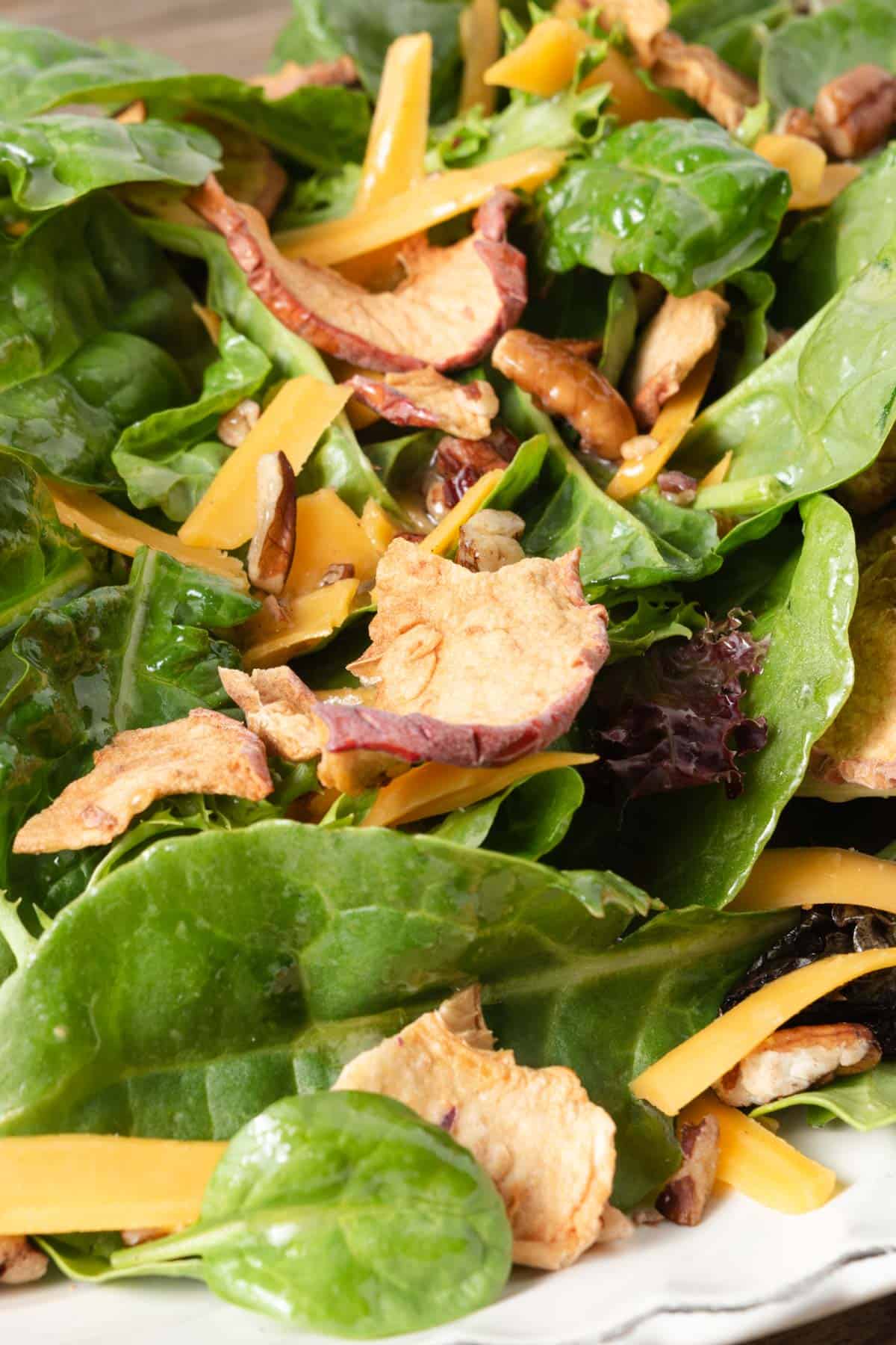 Harvest salad with mixed greens with apple dijon vinaigrette, shredded cheddar, and chopped pecans.