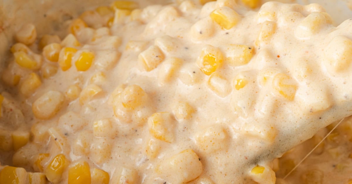 A spoonful of slow cooker cheesy corn with cream cheese.