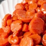 A white platter of brown sugar and bourbon glazed carrots.