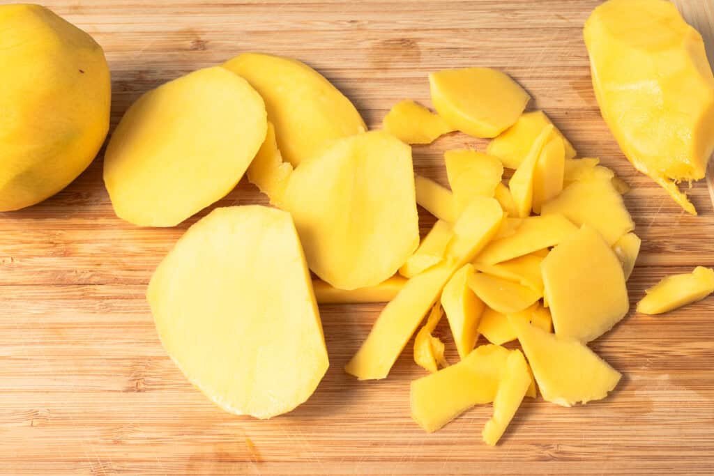 Sliced mangoes on a cutting board.