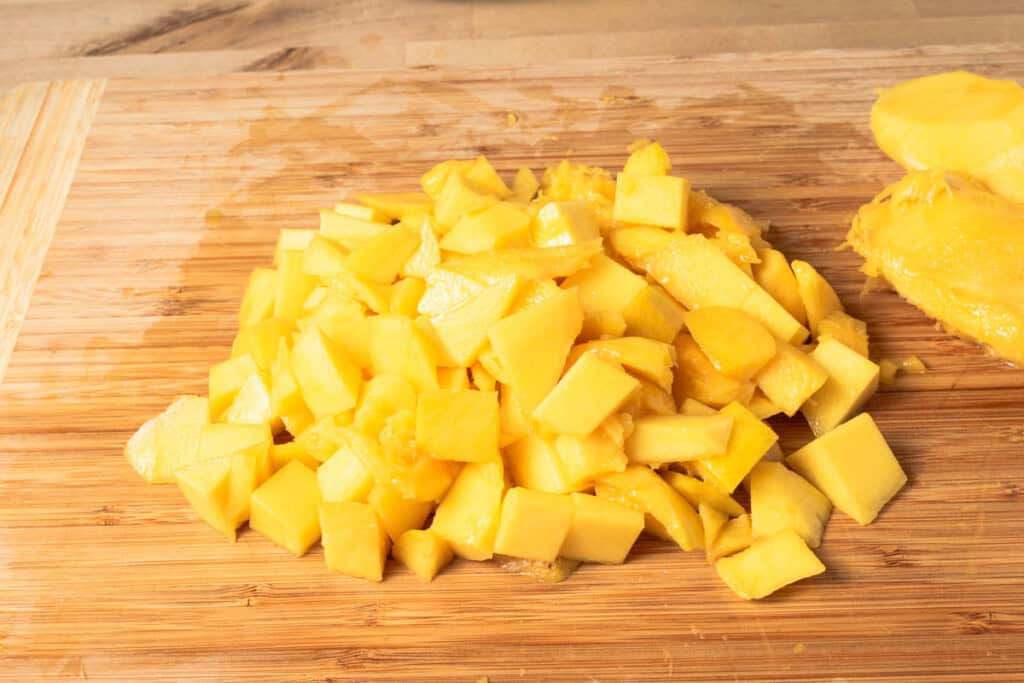 Diced mangoes on a cutting board.