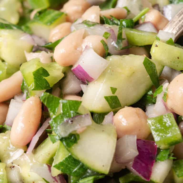 Fresh white bean, chickpea and cucumber salad with bell peppers, onions, and parsley.
