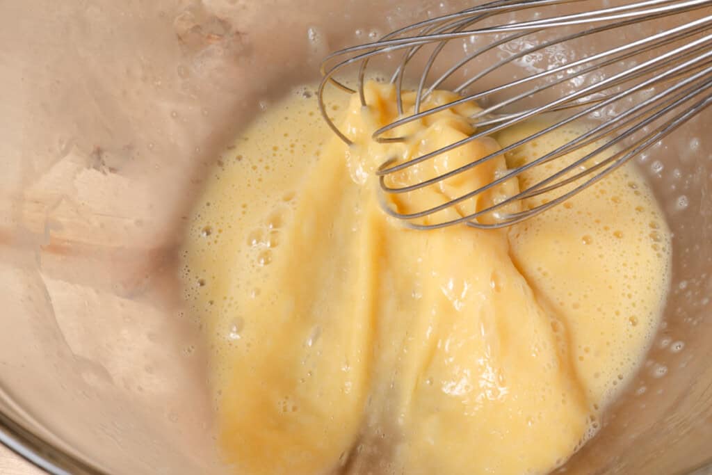 Whisking eggs in a mixing bowl.