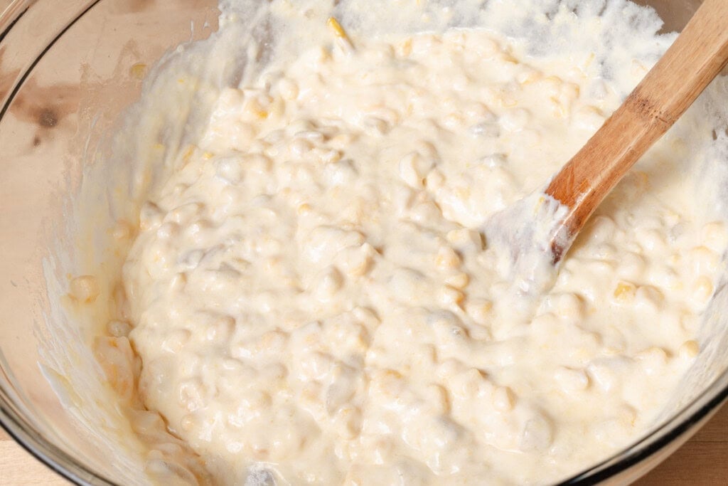 Stirring the wet ingredients together in a bowl.