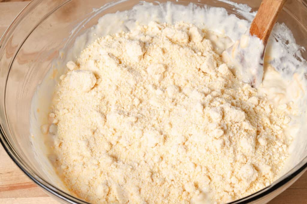 Adding Jiffy corn muffin mix to the batter.