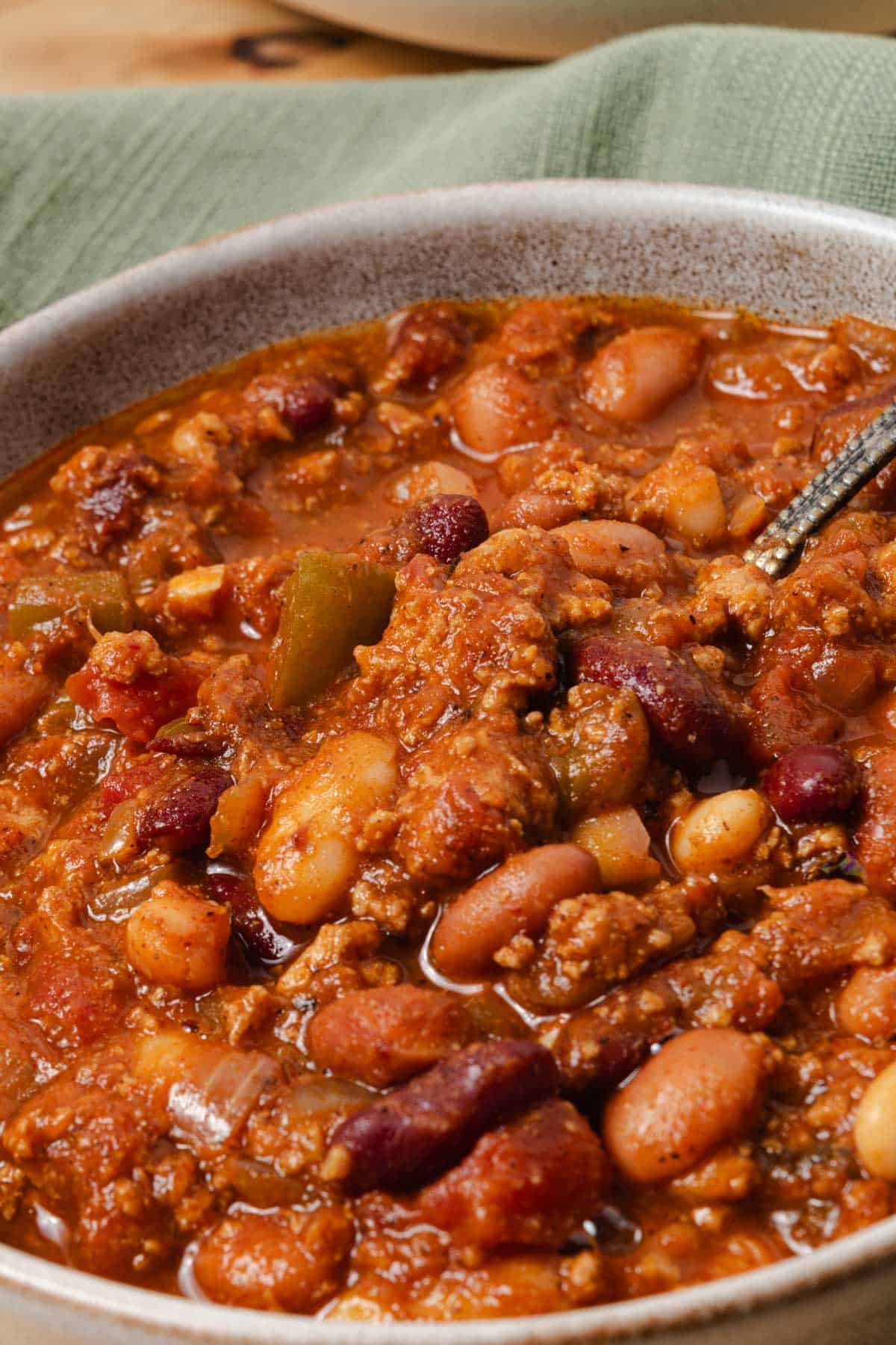 A bowl of homemade pumpkin, turkey, and bean chili.