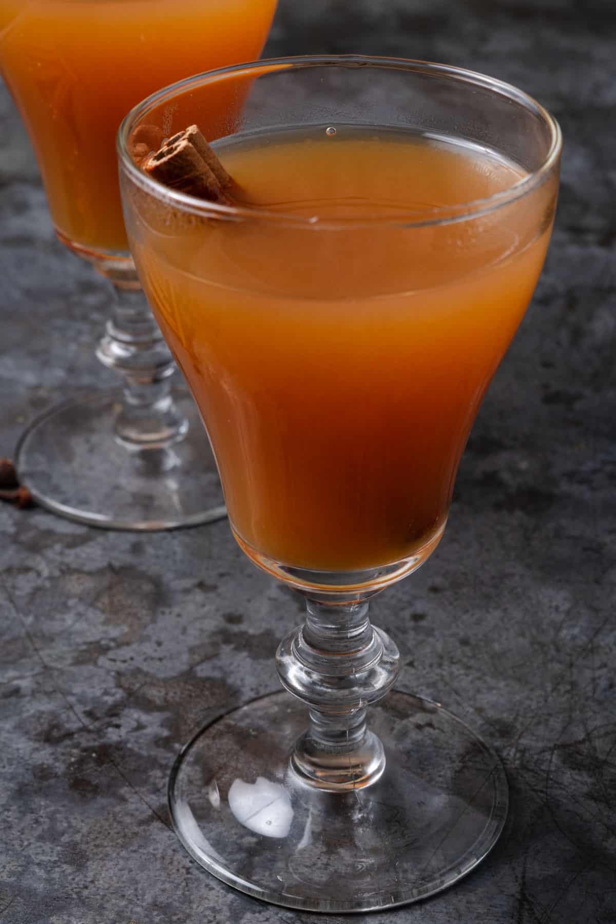 A glass of hot mulled apple cider.