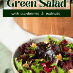 A pin depicting cranberry and walnut green salad.