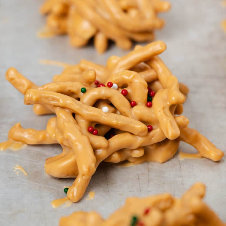 A homemade butterscotch and peanut haystack cookie with red, white, and green sprinkles.