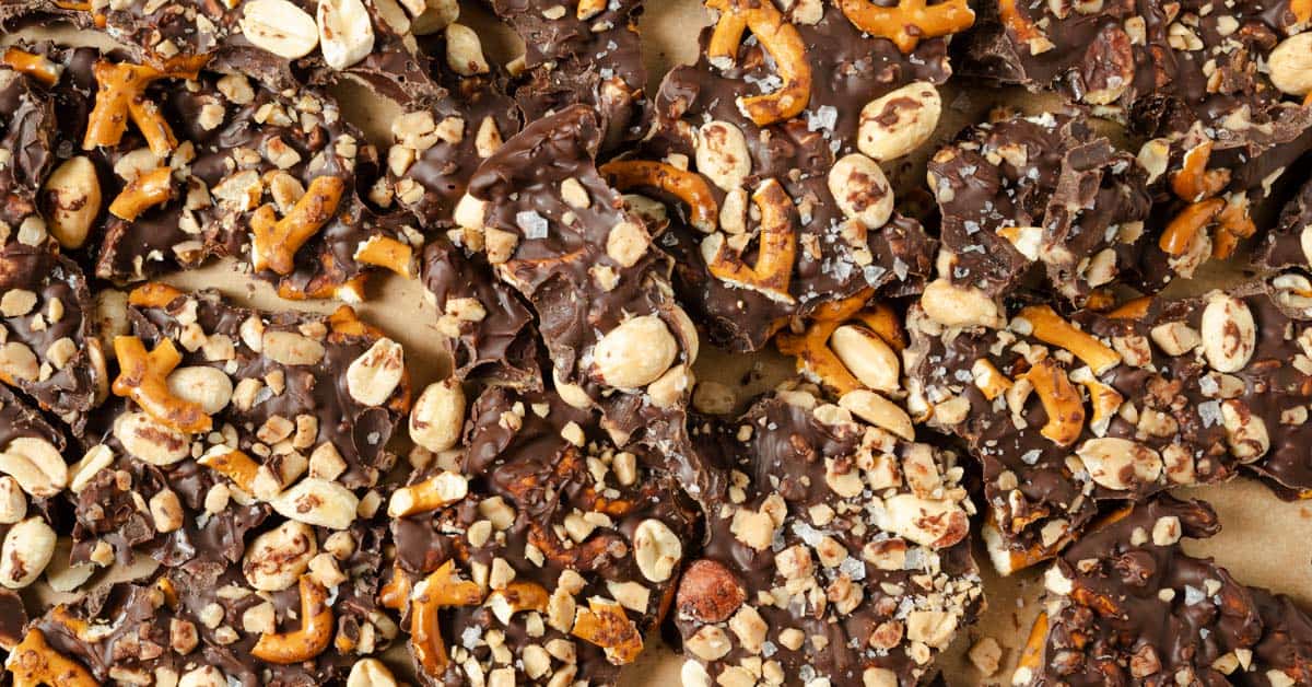 Homemade chocolate bark with pieces of pretzels, peanuts, and toffee.