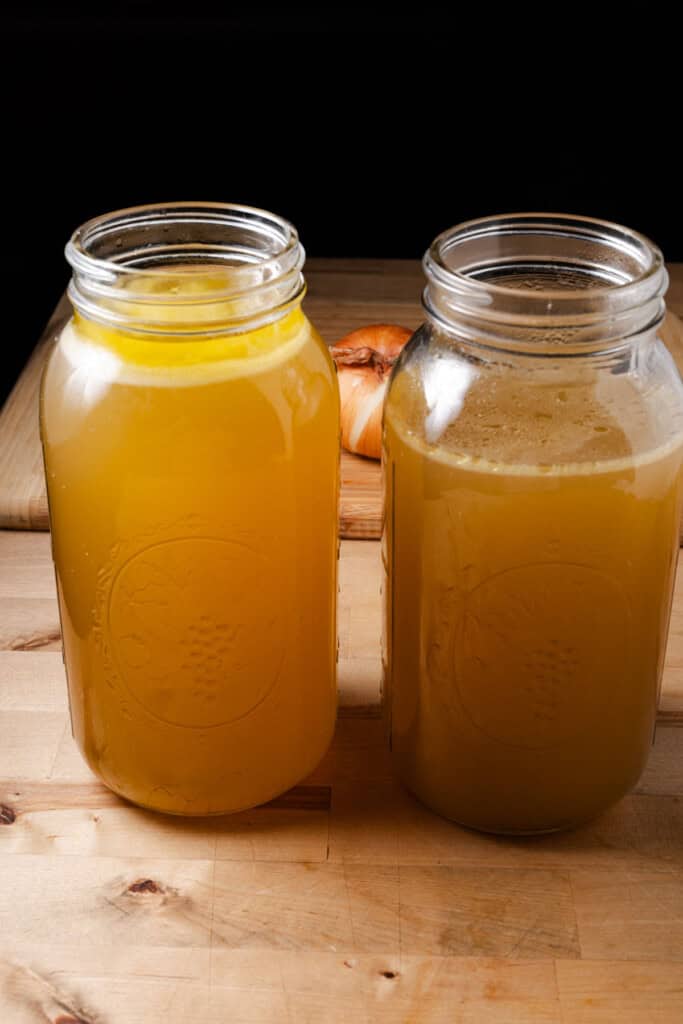 Two half gallon jars full of finished chicken stock.