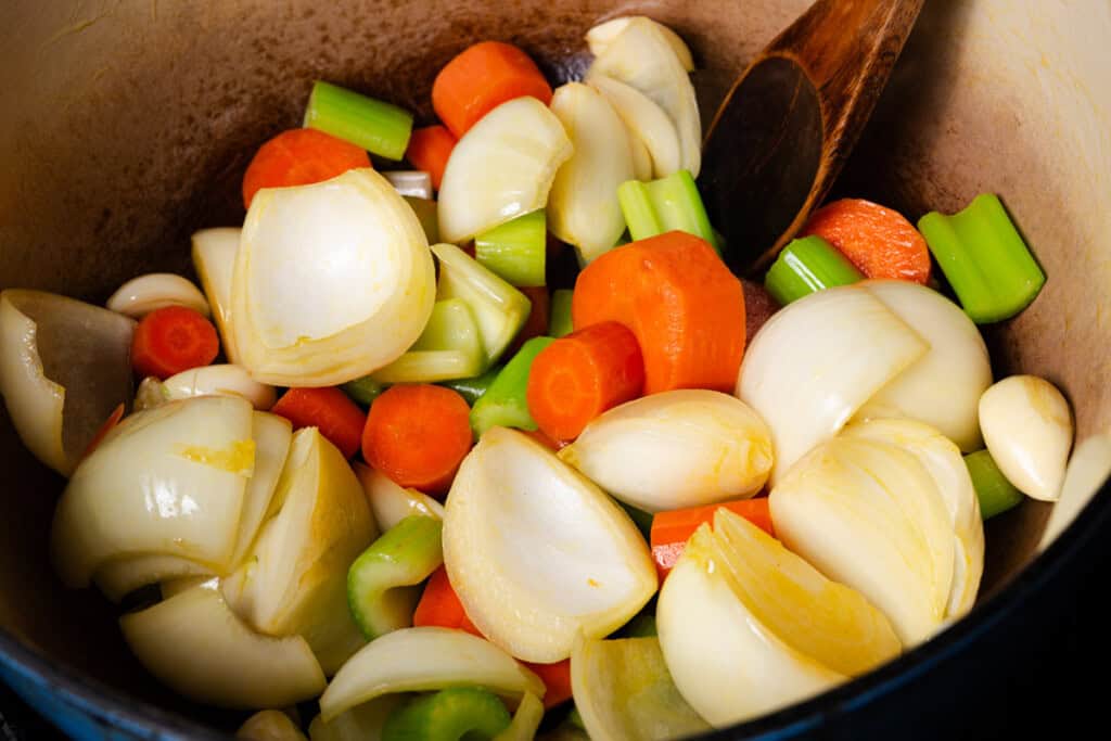 Adding garlic to the pot.