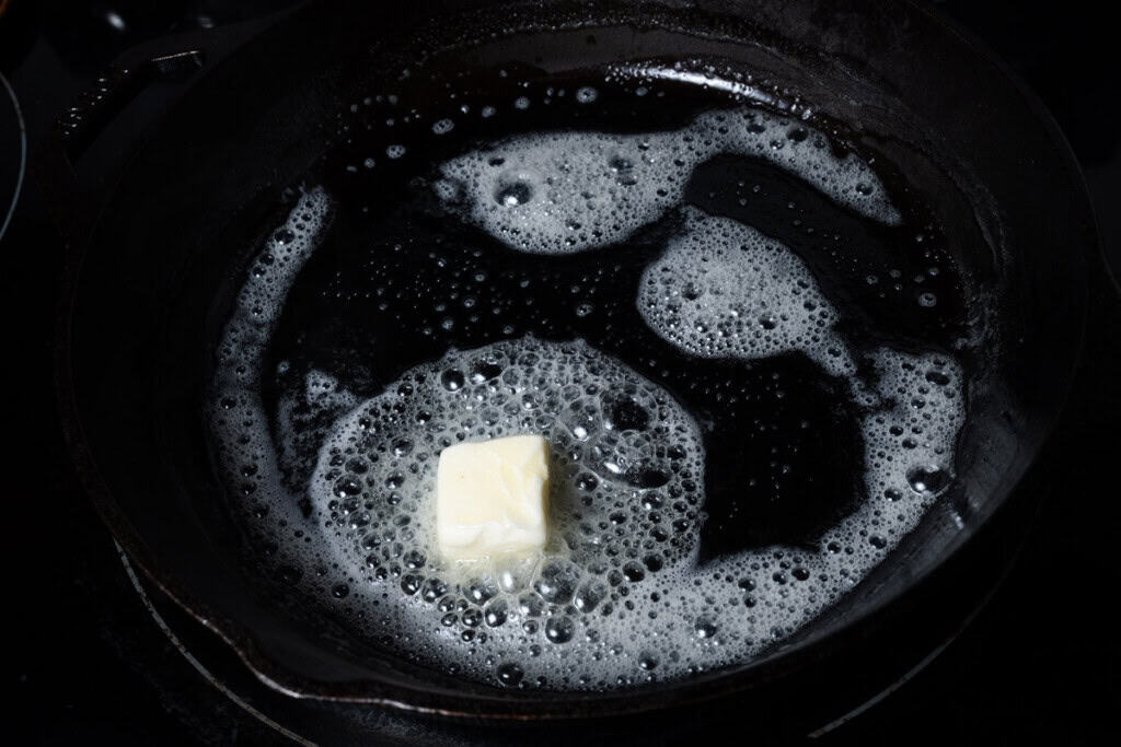Melting butter in a cast iron skillet.