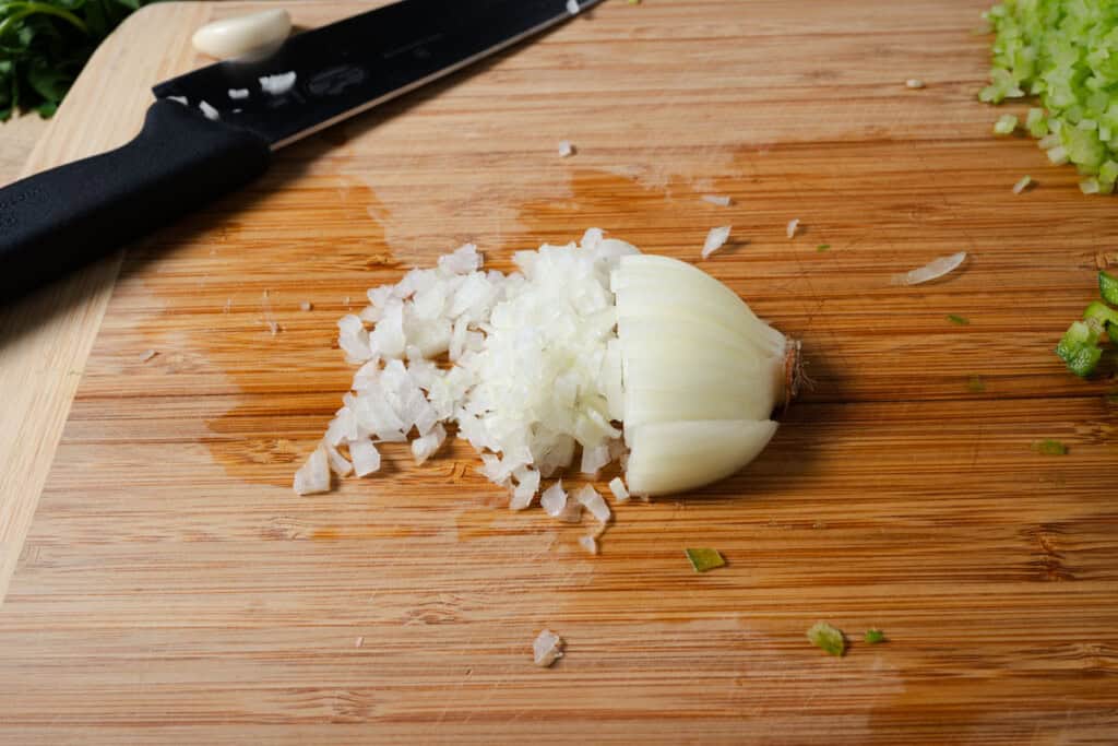 Finely diced onion on a cutting board.