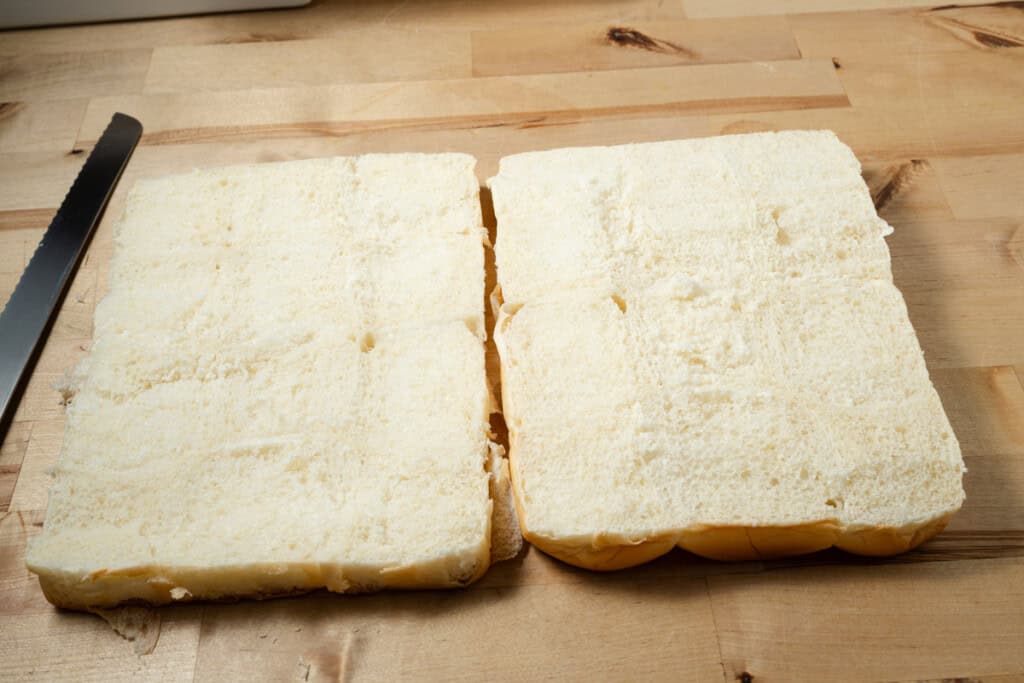 A pack of King's Hawaiian rolls sliders cut in half.