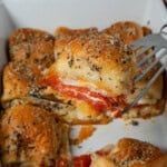 Serving a pepperoni pizza slider with a spatula.