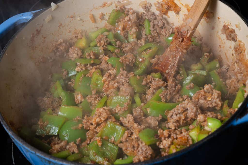 Stirring spices into stuffed pepper.