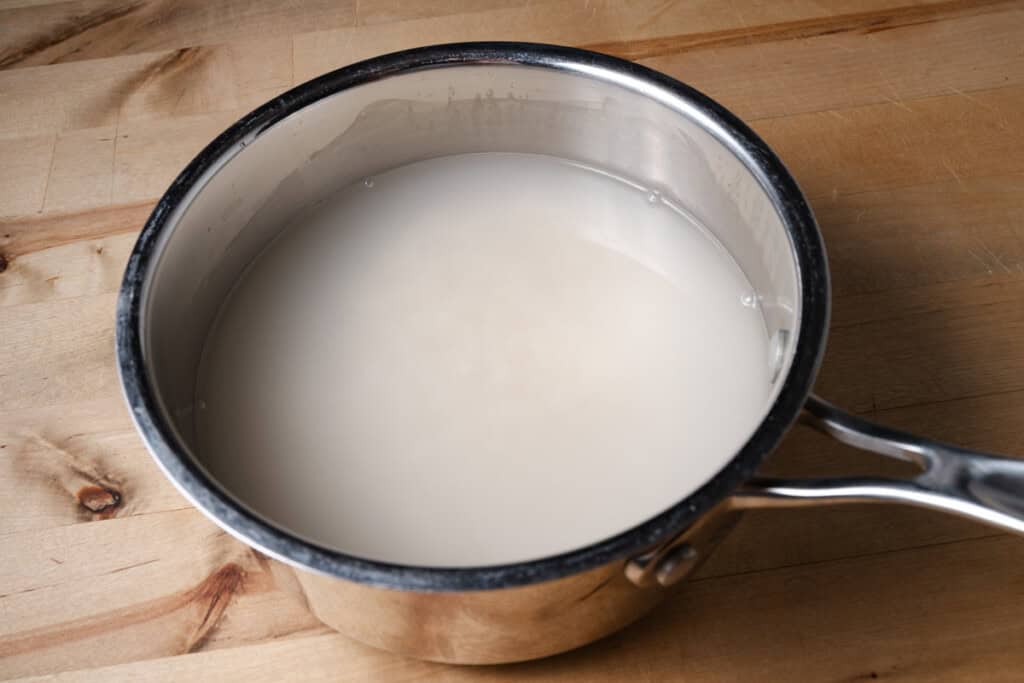 Rinsing rice in a pot.