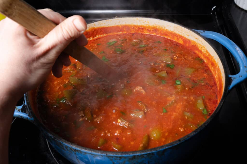 Stirring finished stuffed pepper soup.