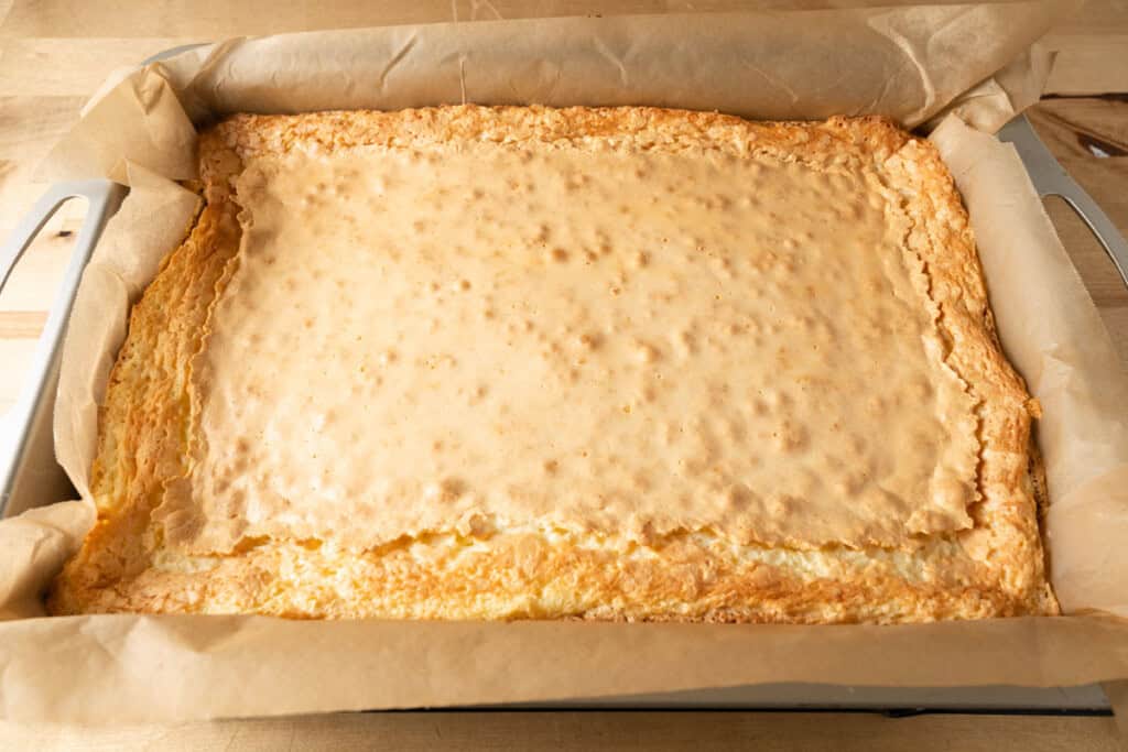 Freshly baked chess bars in a cake pan.