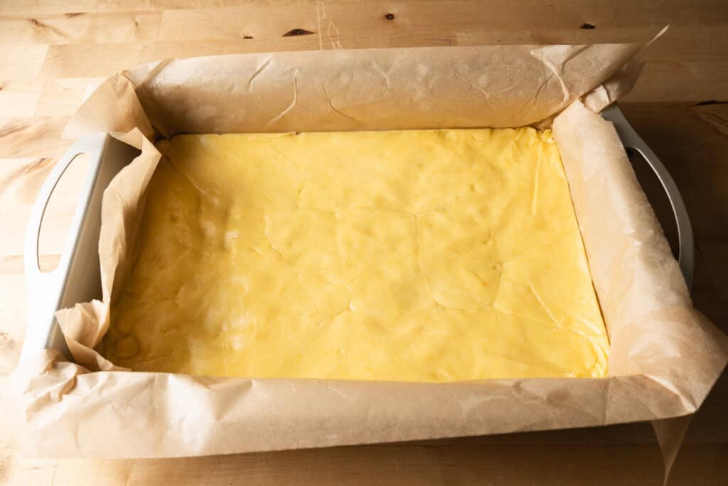 Chess bar crust pressed firmly into a cake pan.