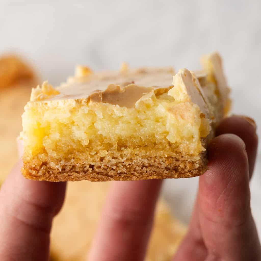 A hand holding a buttery chess bar.