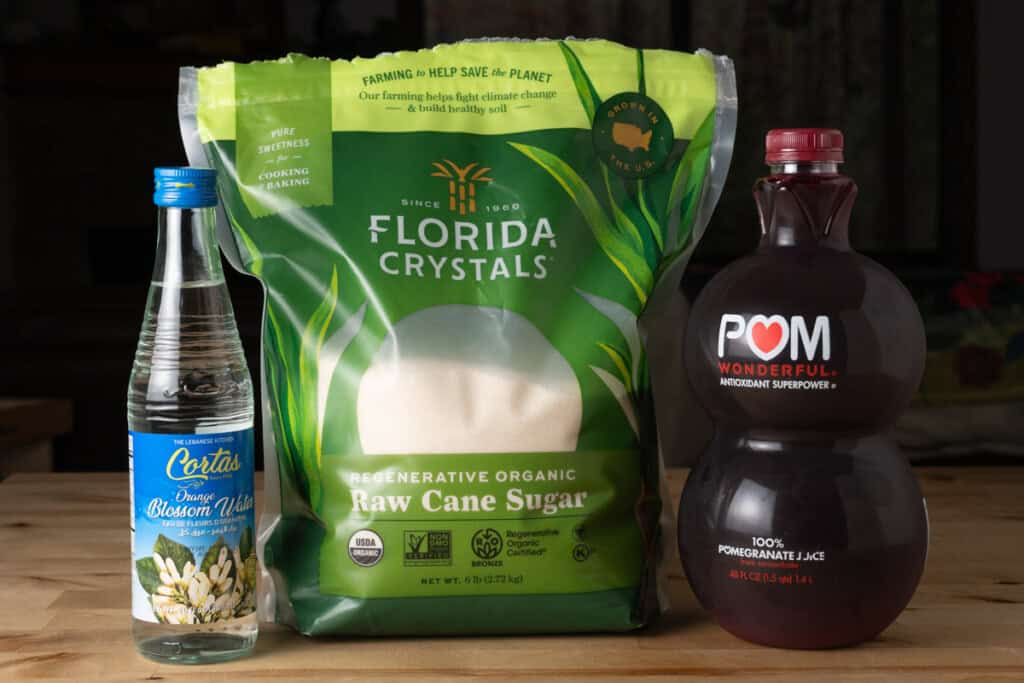 Pomegranate juice, raw cane sugar, and orange blossom water for making homemade grenadine.