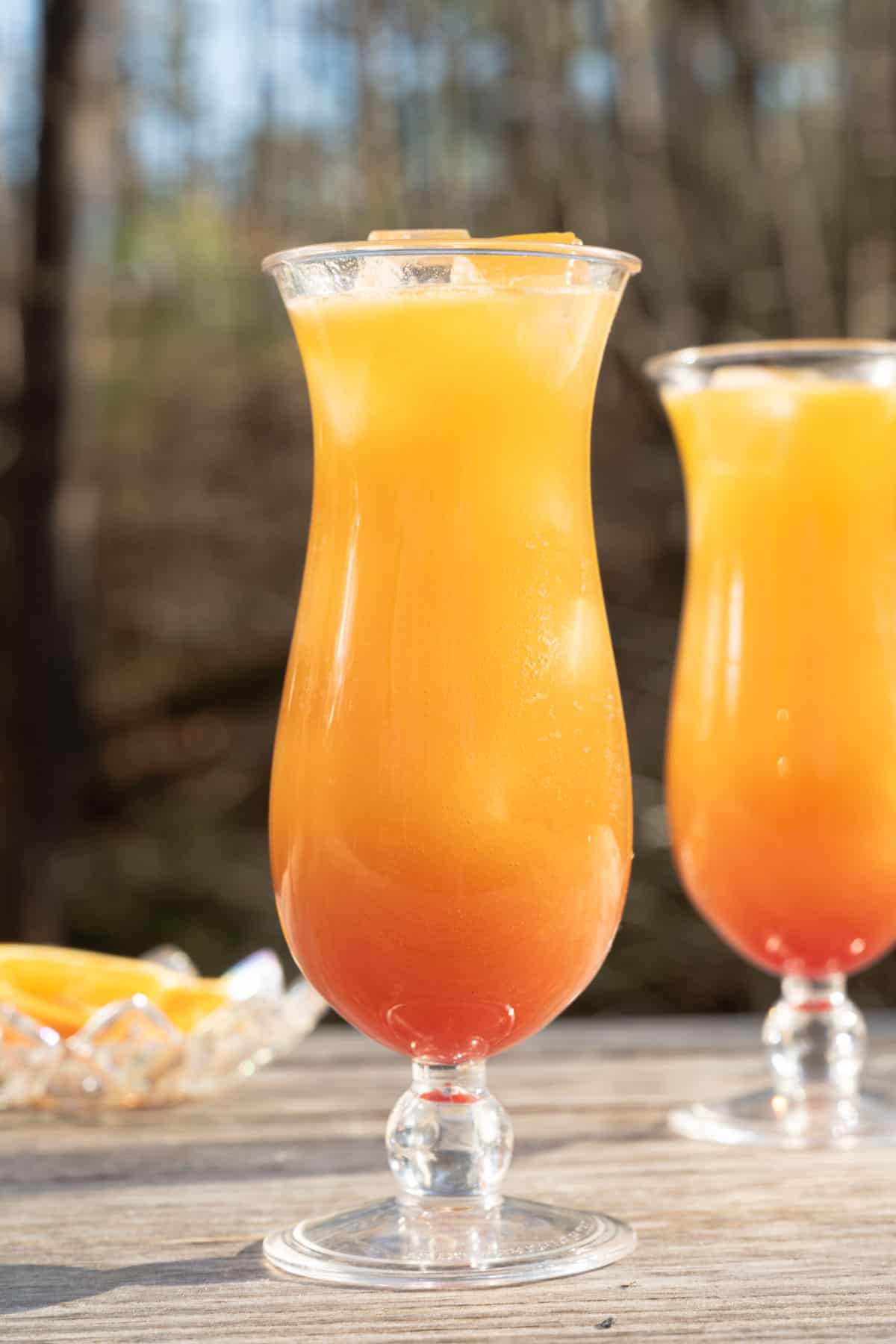 A New Orleans style hurricane cocktail in a hurricane glass.
