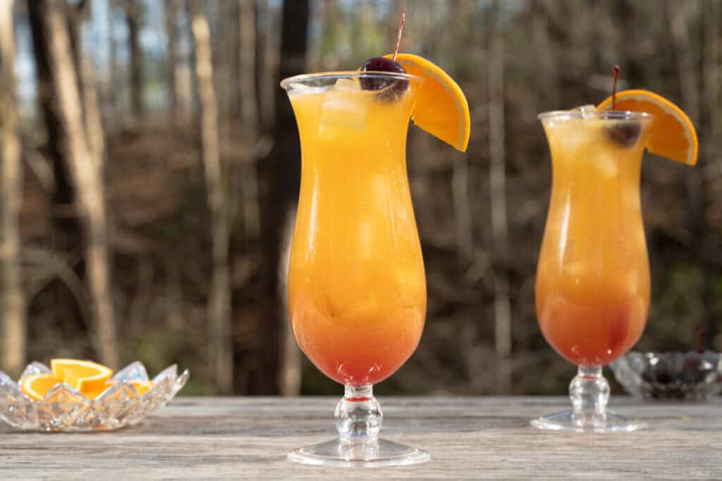 New Orleans style hurricane drinks on an outdoor table.
